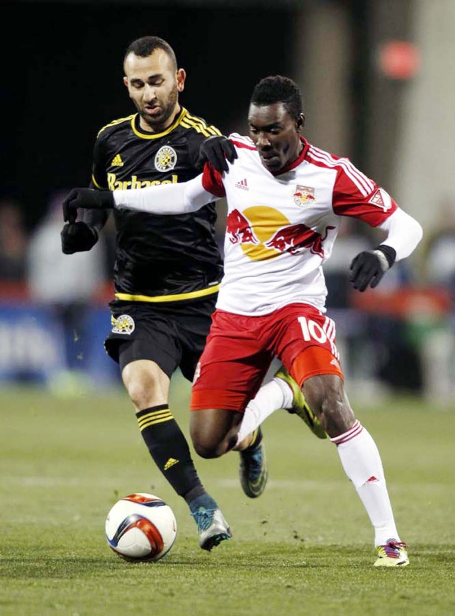 New York Red Bulls midfielder Lloyd Sam (right) works for the ball against Columbus Crew midfielder Justin Meram during the second half in the first leg of the MLS soccer Eastern Conference championship in Columbus, Ohio on Sunday.