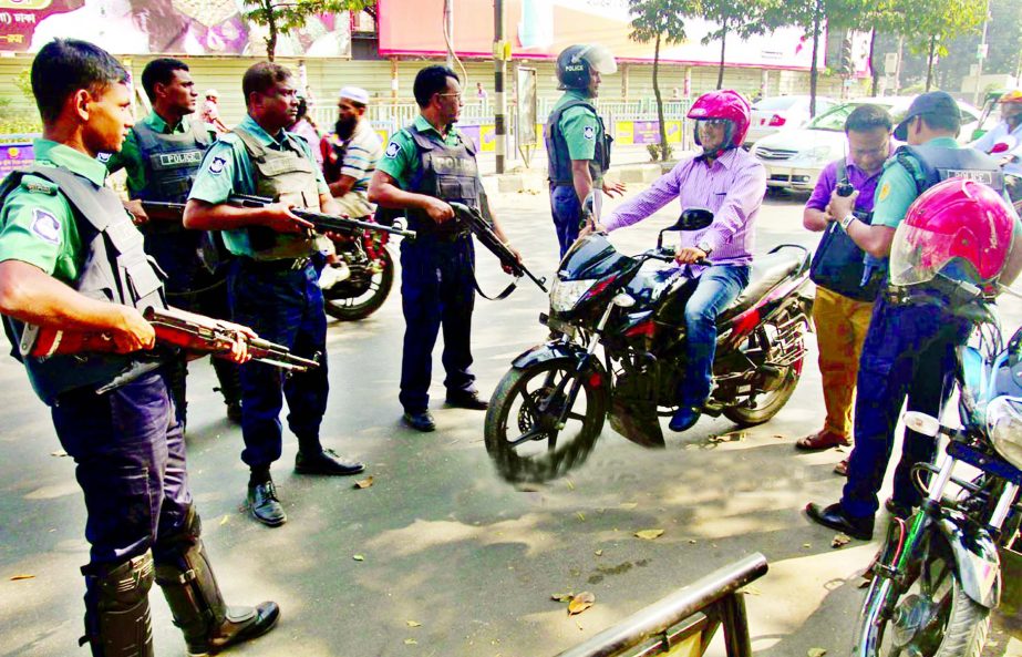 Law enforcers halted a motor-cycle rider for searching to avert any untoward incidents follwing the execution of Salauddin Quader Chowdhury and Ali Ahsan Mojaheed . This photo was taken from Farmgate area on Monday.