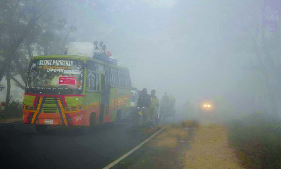 Vehicles plying on the highway with headlight on as dense fog appears in the outskirts of the capital indicating arrival of winter. This photo was taken from Narsingdi area on Thursday.