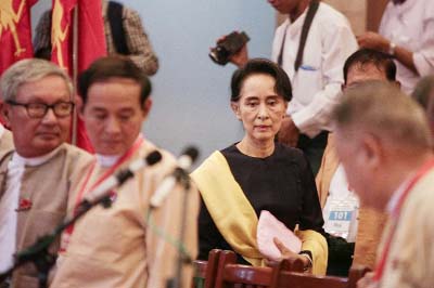 Aung San Suu Kyi (C), leader of the National League For Democracy (NLD) party meets with her elected NLD candidates in Yangon on Friday.