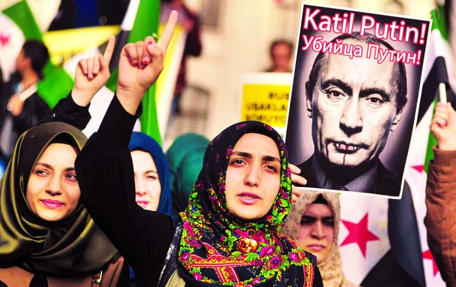 Turkish protesters shout anti-Russia slogans as they hold a poster of Russian President Vladimir Putin that reads in Turkish and Russian Assassin Putin! during a protest in Istanbul.