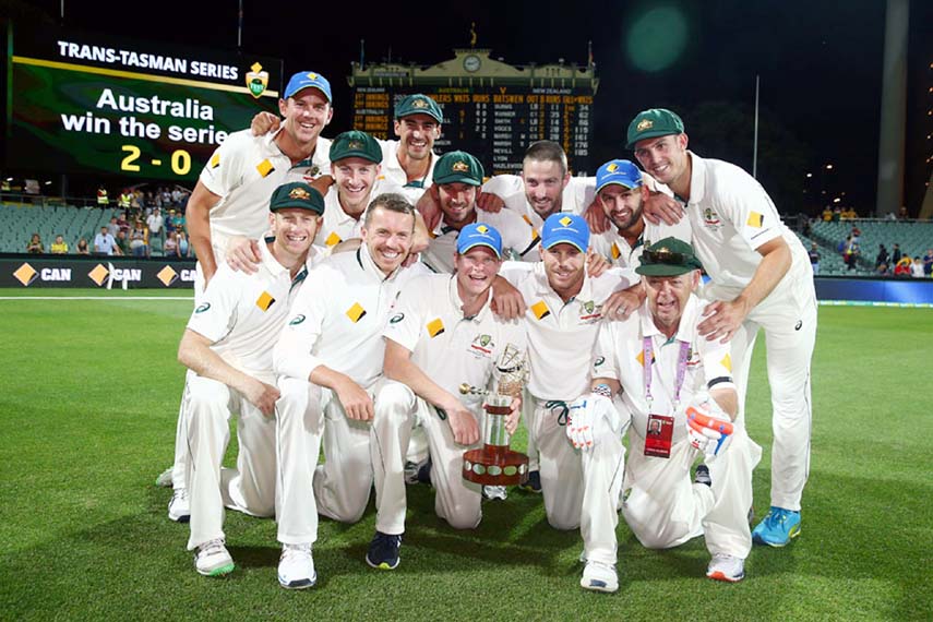 The Australian players pose with the series trophy after beating New Zealand on the 3rd day of the 3rd Test between Australia and New Zealand in Adelaide on Saturday.