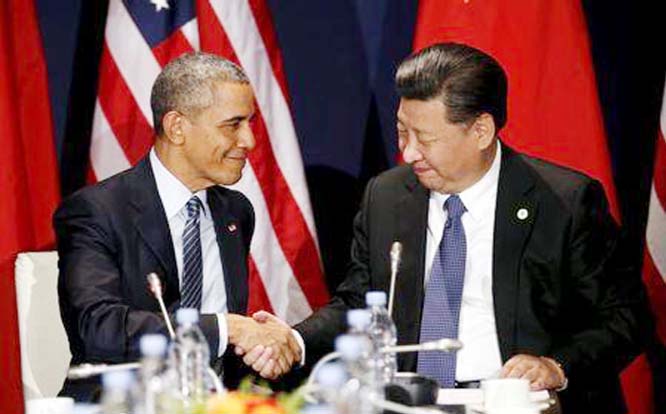 US President Barack Obama shakes hands with Chinese President Xi Jinping during their meeting at the start of the climate summit in Paris on Monday.