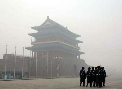 Paramilitary soldiers walk past the Zhengyangmen gate as they patrol at the Tiananmen Square during a heavily polluted day in Beijing, China on Monday.
