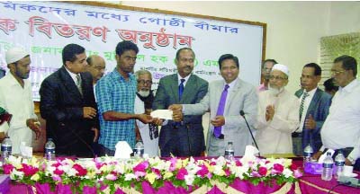 KISHOREGANJ: State Minister for Labour, Manpower and Employment Mojibur Hoque Chunnu MP distributing cheques among the construction workers at Kishoreganj Conference Room on Sunday. DC, GSM Zafarullah chaired the programme. CEO of Zilla Parisahd Md Ani