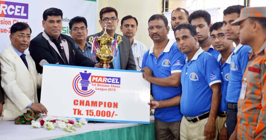 First Senior Additional Director of Walton FM Iqbal Bin Anwar Dawn handing over the champions trophy and a cheque of Tk 15,000 to Fire Service & Civil Defence SC, the champions of the Marcel First Division Chess League at Bangladesh Chess Federation hall-