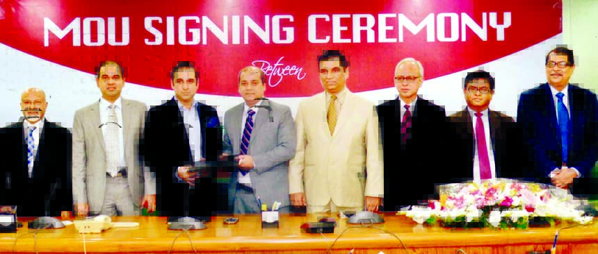 Mohammad Ali, General Manager of Information Technology Division of Pubali Bank Ltd and Amit Razdan, Director of Sales and Marketing of Sea Pearl Beach Resort and Spa, exchanging documents after signing a deal on behalf of their respective companies held