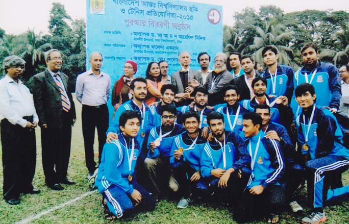 Vice-Chancellor of Dhaka University Professor Dr AAMS Arefin Siddique handing over the championship trophy of the Inter-University Hockey & Tennis Competition to the team leader of National University as the chief guest at the BUET Play Ground on Monday.