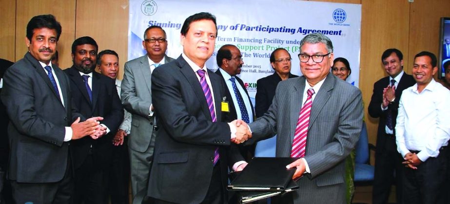 Md. Ahsan Ullah, Executive Director and Project Director of FSSP of Bangladesh Bank and Mohammad Ali, Managing Director of UCB exchanging agreement documents after signing the deal on behalf of the respective organizations at Jahangir Alam Conference Ha