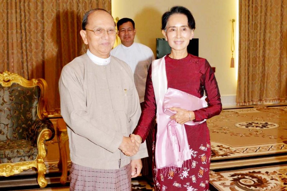 Myanmar outgoing President Thein Sein shaking hands with Aung San Suu Kyi in Naypyidaw on Wednesday.