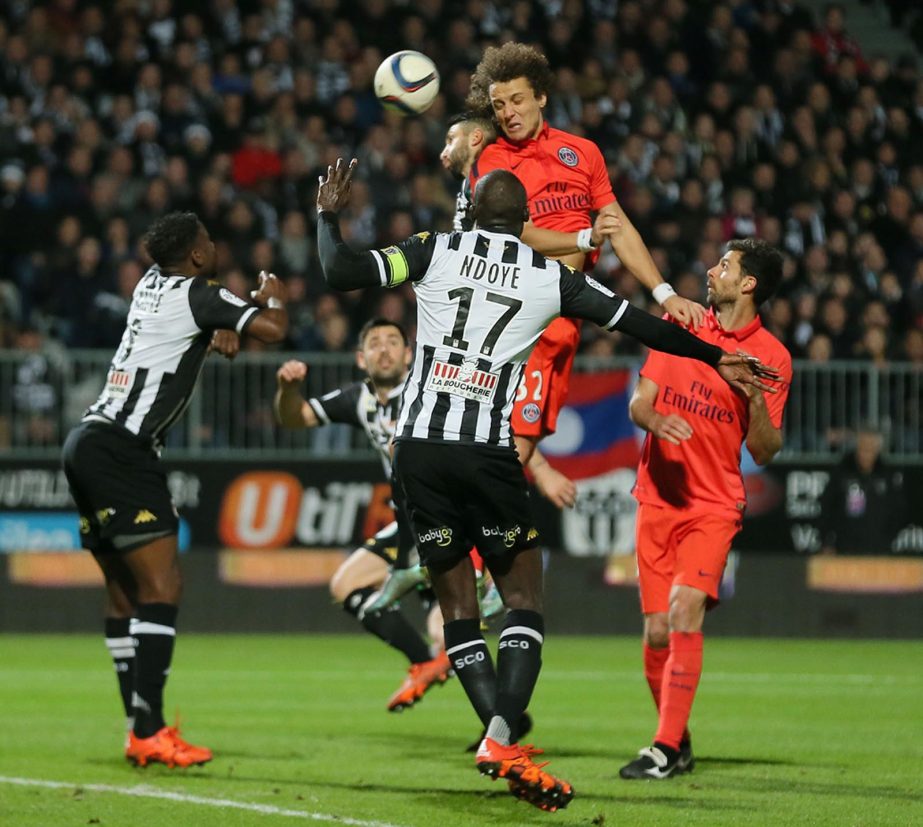 Paris Saint Germain's defender David Luiz of Brazil (top) jumps for a header against Angers' defender Yoann Andreu during their French League One soccer match in Angers, western France on Tuesday.