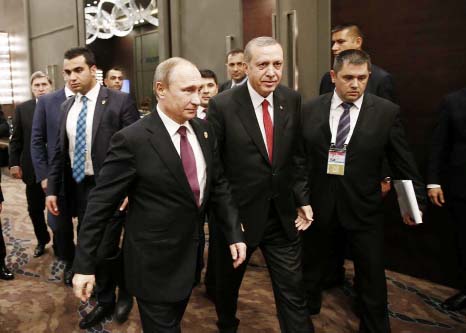 Turkish President Recep Tayyip Erdogan, centre, walks with Russian President Vladimir Putin, left, prior to their meeting at the G-20 Summit in Antalya, Turkey.