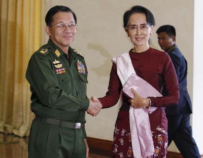 Senior General Min Aung Hlaing (L), Myanmar Commander In-Chief shakes hands with National League for Democracy (NLD) party leader Aung San Suu Kyi before their meeting in Naypyidaw on Wednesday.