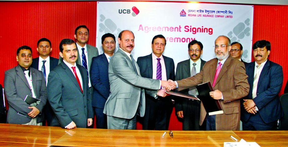 Mirza Mahmud Rafiqur Rahman, Additional Managing Director of UCB and Mohammad Tarek Chief Financial Officer of Meghna Life Insurance Ltd exchanging the documents after signing the agreement on behalf of their respective organizations in the city on Wednes