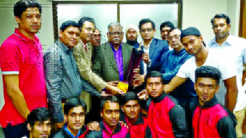 The members of the National University Hockey & Tennis team and Vice-Chancellor of National University Harun-or-Rashid pose with the championship trophy of the Inter-University Hockey & Tennis Competitions at the National University in Gazipur on Wednesda
