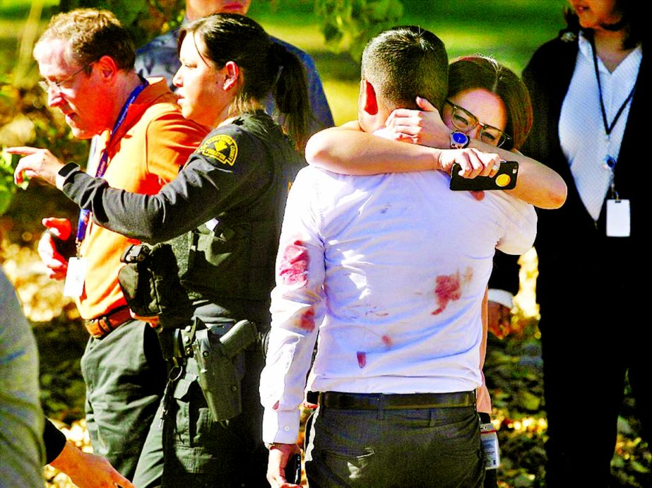 A couple embraced in shock following a mass shooting at the Inland Regional Center that left 14 people dead in San Bernardino, California. Internet photo