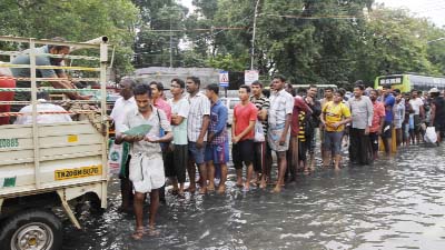 Hundreds of Flood-affected people queuing for relief in Chennai on Thursday.