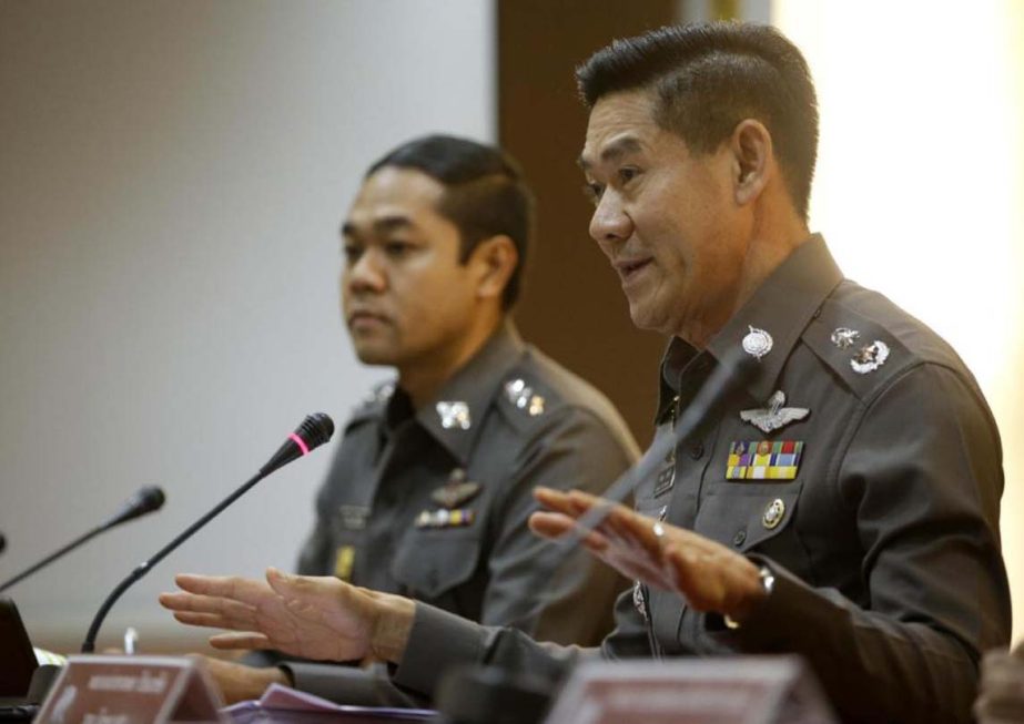 National police deputy spokesman Col. Songpol Wattanachai, right, gestures as he addresses a press conference in Bangkok, Thailand on Friday.