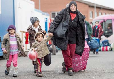 Asylum seekers arrive at a first registration centre for refugees in Giessen, western Germany on Thursday.