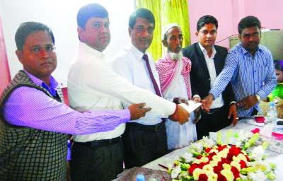 NASIRNAGAR(B'baria): Md Mofizul Islam, Assistant Vice President of National Life Insurance Company Ltd handing over a death claim cheque to the father of a client Abul khaer at a function recently.