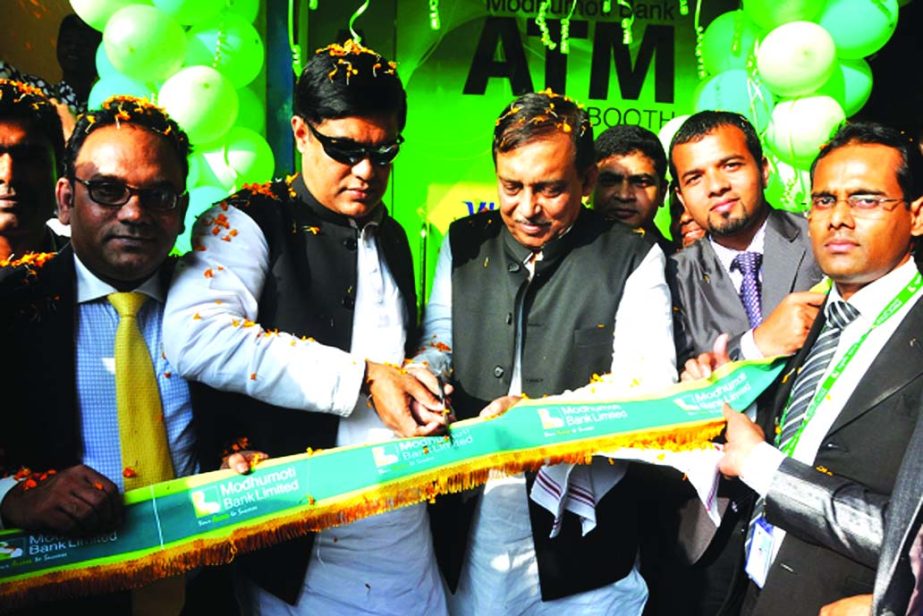 Home Minister Asaduzzaman Khan, MP, inaugurating an ATM Booth of Modhumoti Bank Limited at Charfassion Branch, Bhola on Saturday. Abdullah Al Islam Jakob, MP, Deputy Minister for Environment and Forests was present as special guest.