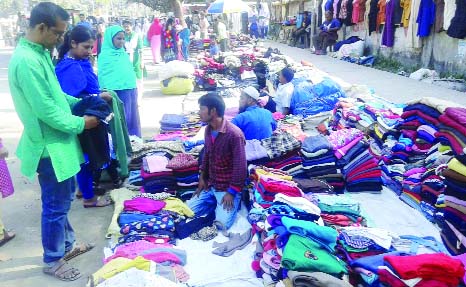 RANGPUR: Customers buying winter clothes at makeshift shops in Rangpur city on yesterday.