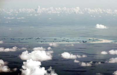 This aerial photo taken through a glass window of a military plane shows China's alleged on-going reclamation of Mischief Reef in the Spratly Islands in the South China Sea.