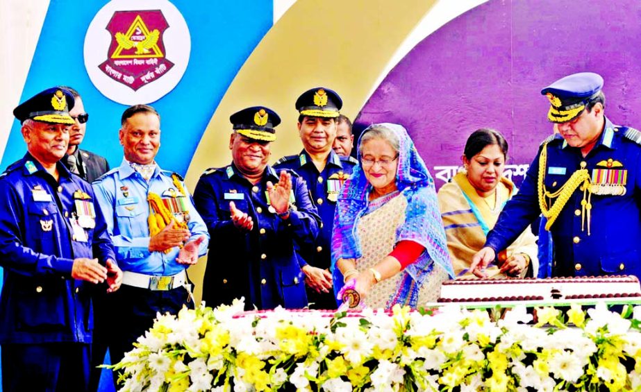 Prime Minister Sheikh Hasina cutting a cake at the induction ceremony of YAK-130 Trainer Aircraft and Maritime Search and Rescue Hel Augusta AW-139 in Air Force at Air Base Bangabandhu in Dhaka Cantonment on Sunday. BSS photo