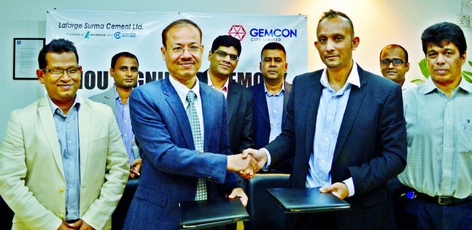 Masud Khan, Finance Director of Lafarge Surma Cement Ltd and Syed Nayeem Abdullah, Chief Operating Officer of Gemcon City Limited sign an agreement at the Lafarge Surma Cement head office in Gulshan, Dhaka recently.