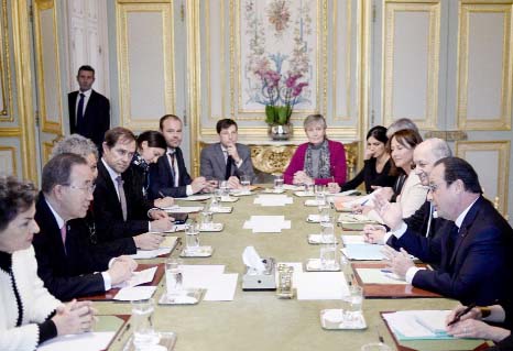 France's President Francois Hollande, (right) talks with Secretary General of the United Nations Ban Ki-moon, (second from left) during a meeting, at the Elysee Palace, in Paris on Sunday.