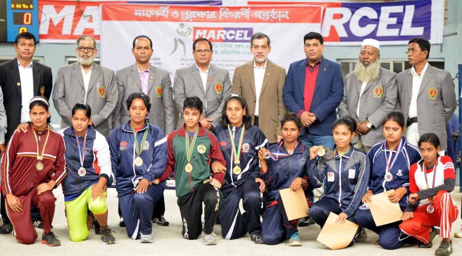 Female boxers of Bangladesh Ansar, the champions of the Marcel National Women's Boxing Competition with the guests and officials of Bangladesh Amateur Boxing Federation pose for a photograph at the Muhammad Ali National Boxing Stadium in Paltan Maidan o