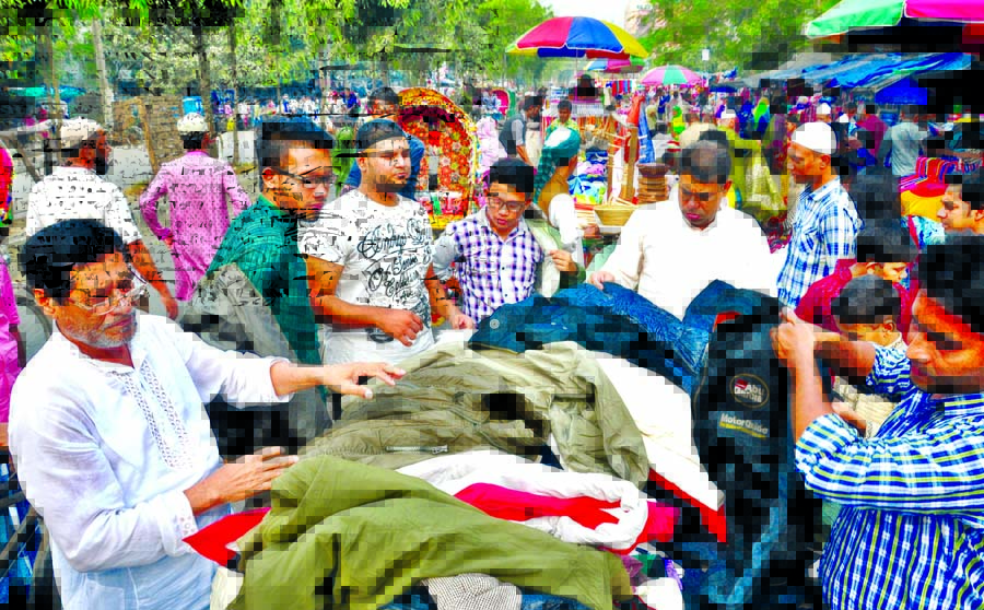 Brisk business of winter clothes is taking place almost everyday claiming as Holiday Market in front of Motijheel Ideal School and College causing sufferings to commuters, students as well as pedestrians. This photo was taken on Monday.