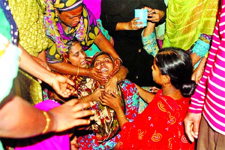 Mother wailing as her minor boy Ismail Hossain Nirob (inset) who fell into a sewerage drain in city's Shyampur area found dead on Tuesday.