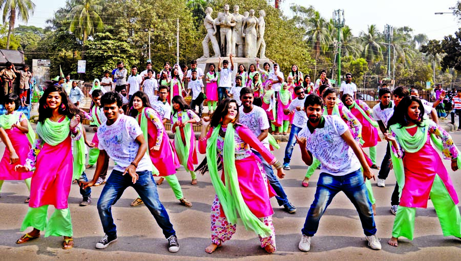 Students of Bengali Department of Dhaka University of 2011-'12 session observing 'Rag Day' by performing dance on the university campus on Wednesday.