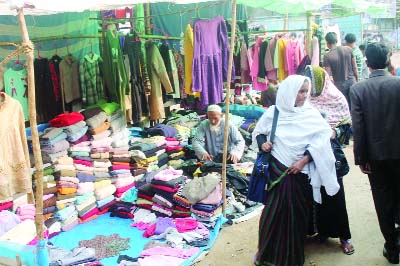 JHENIDAH: Women rush at a warm clothes shop at Jhenaidah town.