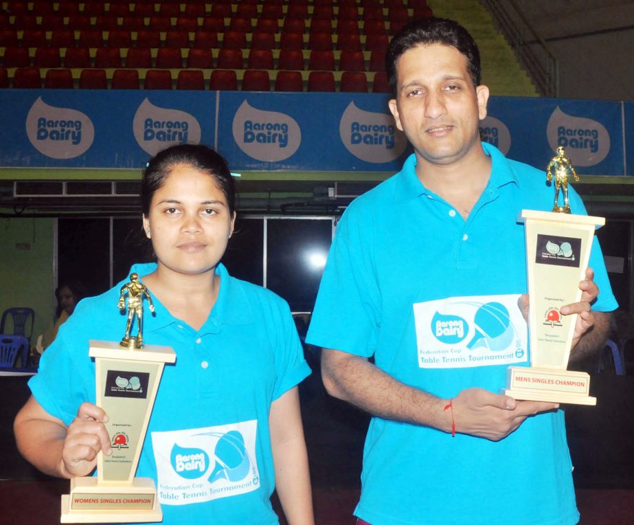 Manas Chowdhury (right) of ANH Travels, the champion of the men's singles of the Aarong Dairy Federation Cup (Ranking) Table Tennis Tournament and Rahima Akter of Bangladesh Army, the champion of the women's singles pose for a photo session at the Shahe