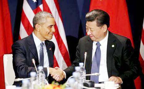 US President Barack Obama shakes hands with Chinese President Xi Jinping during their meeting at the start of the climate summit in Paris