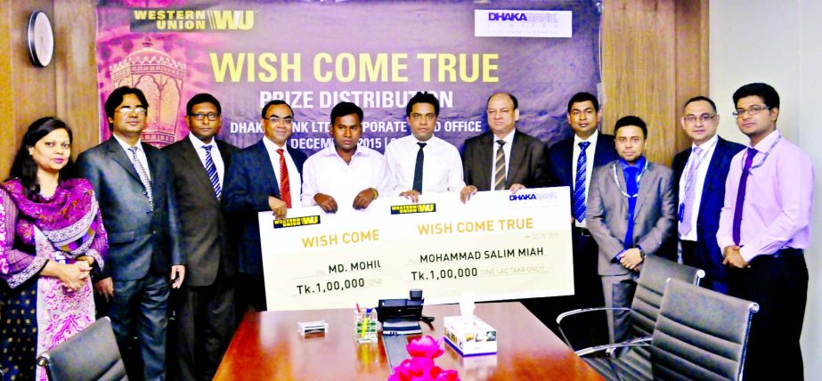 Md Mohiuddin and Mohammad Salim Miah, winners of "Wish come true" organized by Dhaka Bank and Western Union, poses with the cheque of Tk 1 lakh each at a ceremony in the city recently.