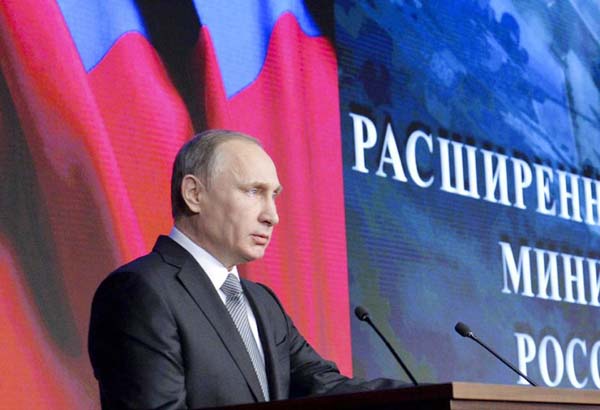 Russian President Vladimir Putin delivers his speech during a meeting with top military officials in Moscow, Russia on Friday.