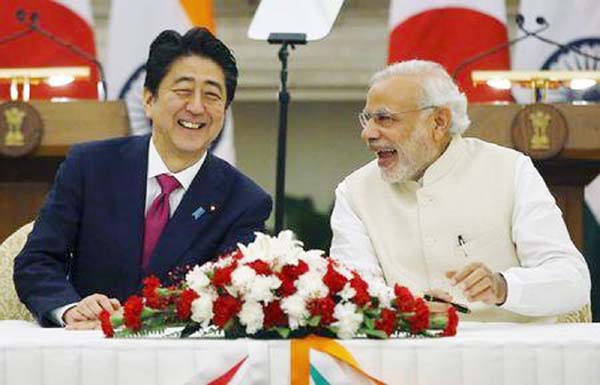 Japan's Prime Minister Shinzo Abe (L) and his Indian counterpart Narendra Modi shares a moment during a signing of agreement at Hyderabad House in New Delhi, India on Saturday.