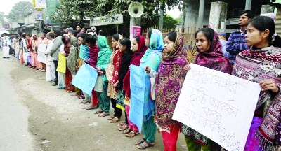 DINAJPUR: Locals in Dhchi village formed a human chain protesting attack on Kaharol ISKON Temple in Dinajpur on Friday.