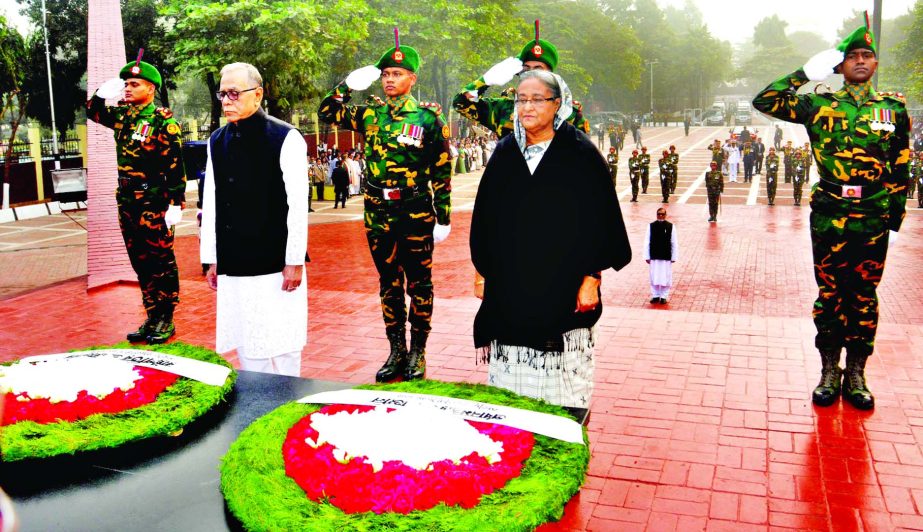 President Abdul Hamid and Prime Minister Sheikh Hasina stand in solemn silence after placing wreaths at the Mirpur Martyred Memorial marking the Martyred Intellectuals Day on Monday.