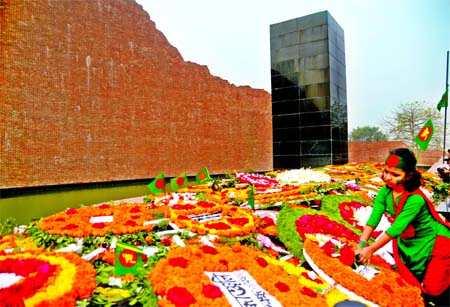 The Martyred Intellectuals Memorial bedecked with flowers as people of all strata of life thronged the spot to pay their respects marking the day at Rayerbazar on Monday.