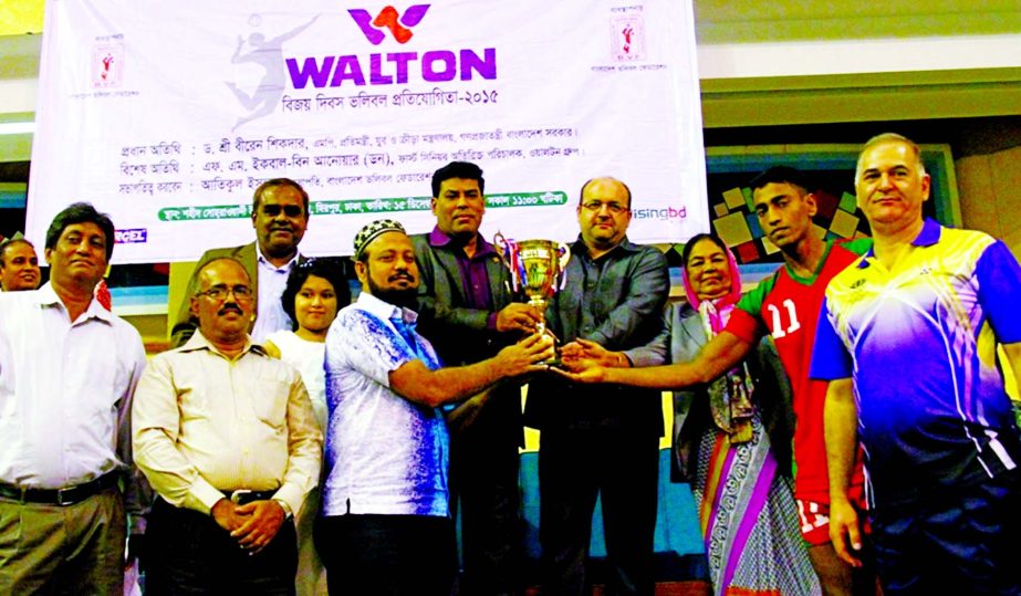 Team Leader of Bangladesh National Men's A team receiving the championship trophy of the Walton Victory Day Volleyball Tournament at the Shaheed Suhrawardy Indoor Stadium in Mirpur on Tuesday.