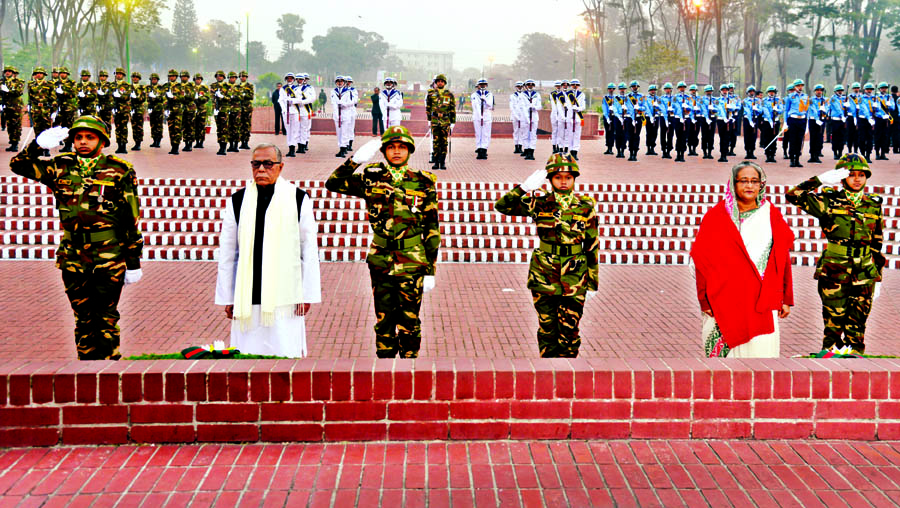 President Abdul Hamid and Prime Minister Sheikh Hasina stand in solemn silence at the alter of Savar Mausoleum after placing wreaths and paid homage to Martyrs marking the 45th Victory Day on Wednesday.