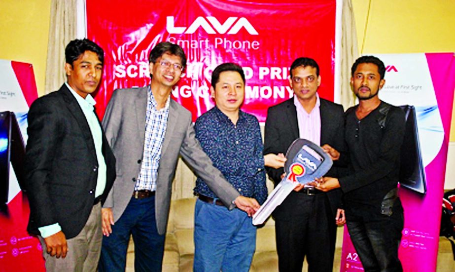 Alex EU, Country Manager of LAVA, a smart phone company, handing over the award of scratch card winners in the city recently. CMO Eron Mao, Marketing Manager Md Kamrul Islam of LAVA were present.