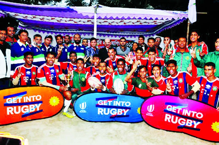 Bangladesh Army Red team, the champions of the Victory Day Rugby Competition with the guests and the officials of Bangladesh Rugby Federation pose for a photo session at the Paltan Maidan on Friday.