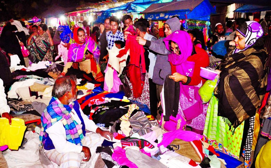 Brisk sale of warm clothes on rise as customers crowded the city and makeshift shops at the be ginning of the month of Poush. This photo was taken from Motijheel Holiday market on Friday.