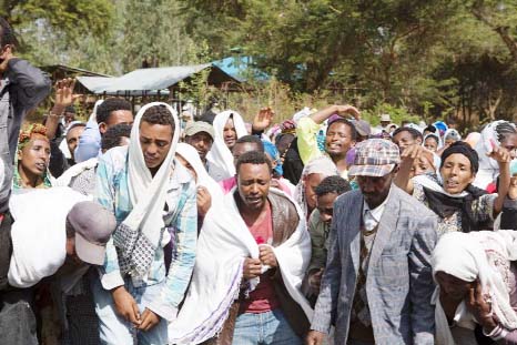 People mourn the death of Dinka Chala who was shot dead by the Ethiopian forces the day earlier, in the Yubdo Village, about 100 km from Addis Ababa.