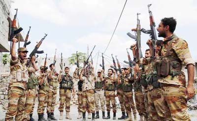 Soldiers loyal to Yemen's government raise their weapons following a training exercise in the country's southwestern city of Taiz.